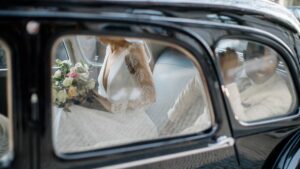 Noivos dentro de um carro antigo